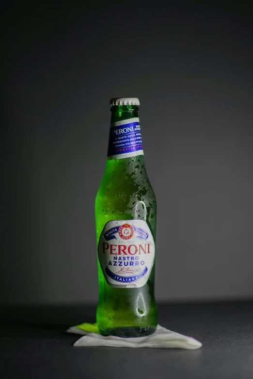 a green beer bottle is sitting on the table