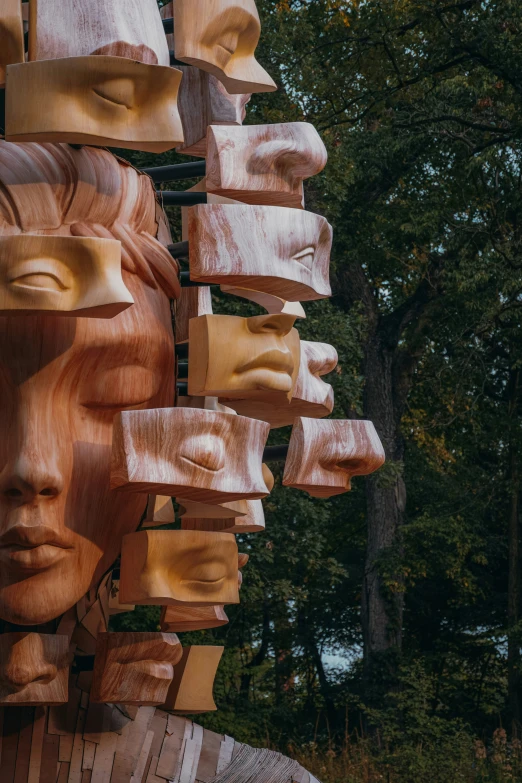 some wood faces and faces on a wall