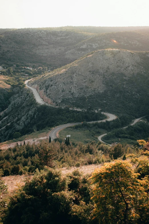 a view of a beautiful valley with some hills around it