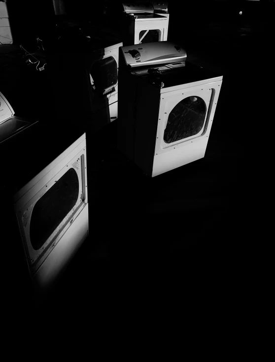 a group of stoves in the dark with dark lighting