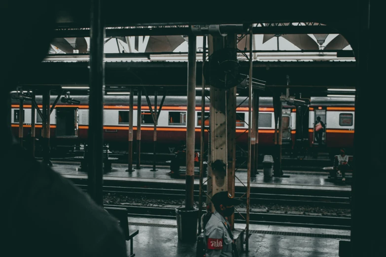 a train is passing by people in the station