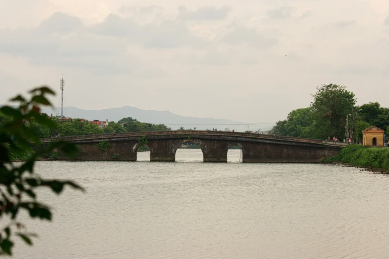 a bridge with a train on it spanning water