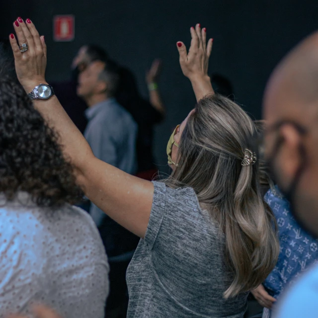 people with their hands raised in a bar