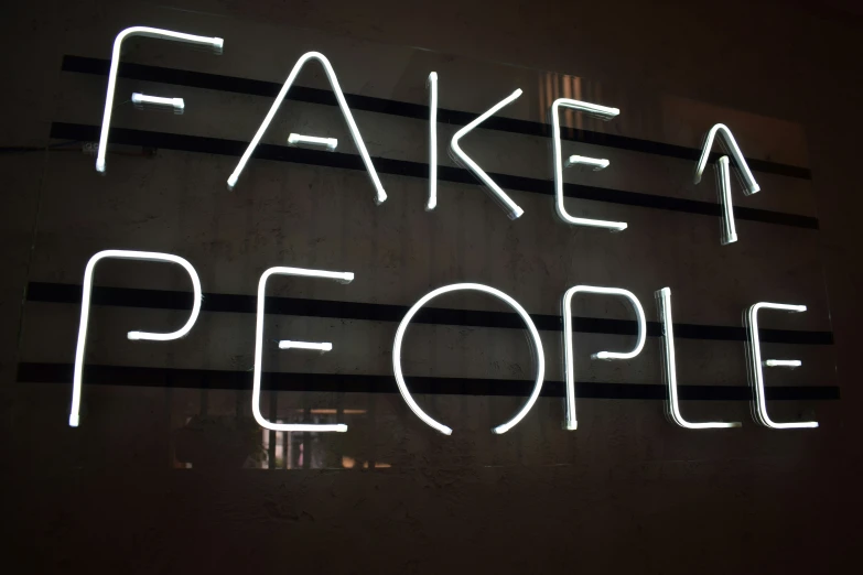 a neon sign that reads fake people