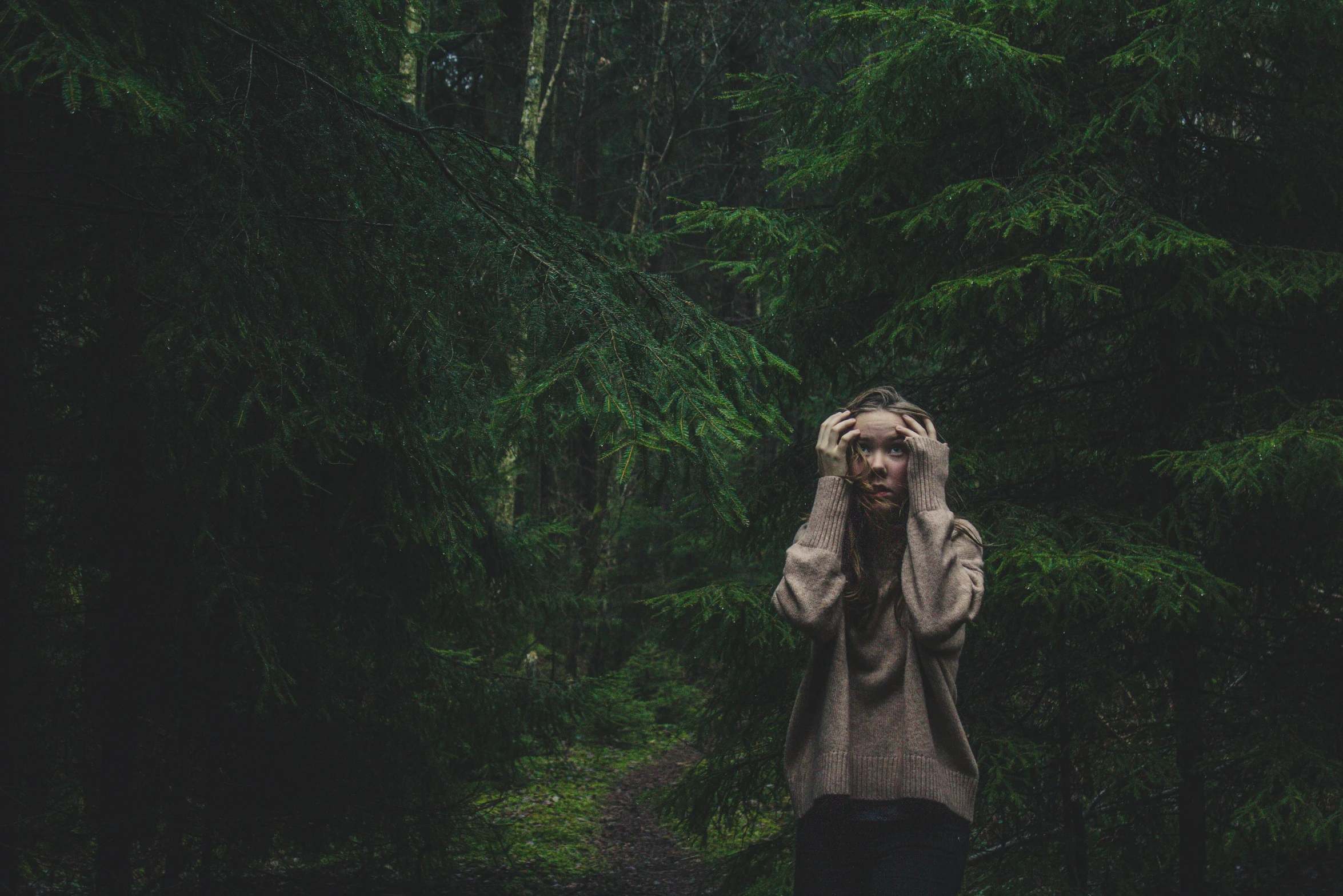 a woman covering her eyes with her hands