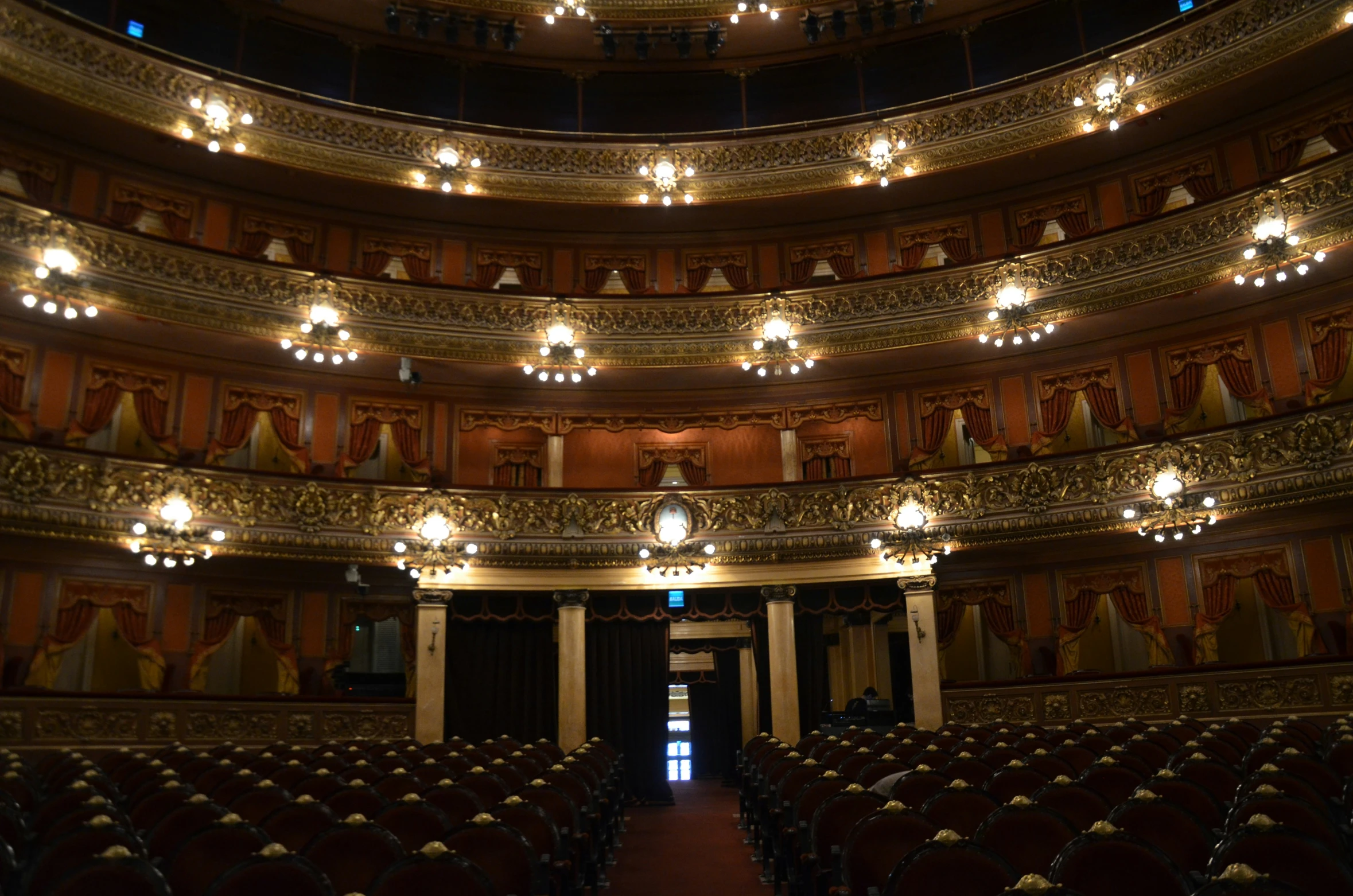 a long room filled with lots of seats in front of a stage