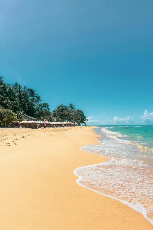 a beach with clear blue water and white sandy shore