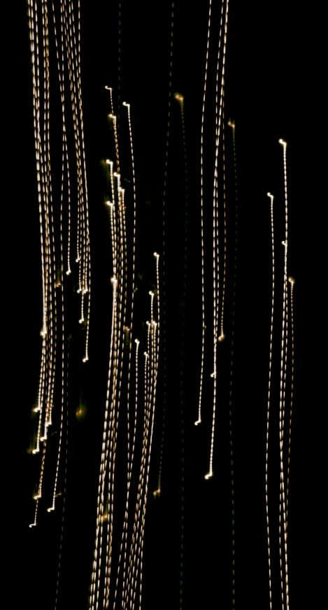 gold chain lights shine on black background