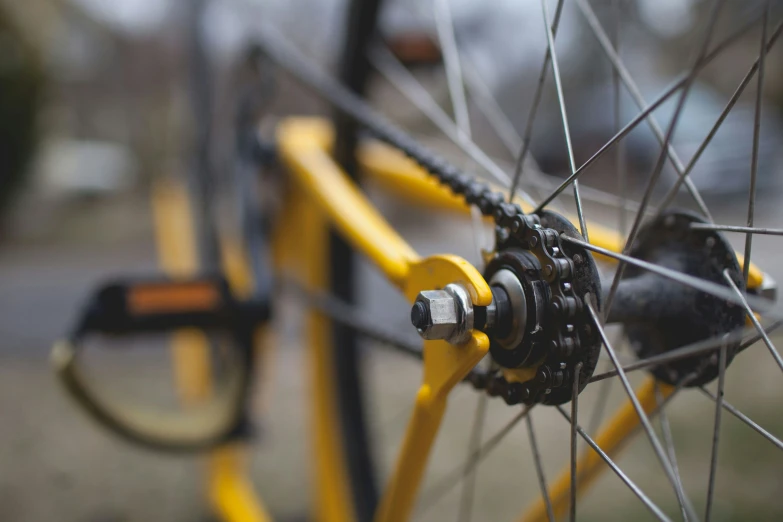 the spokes and wheel of a bike are yellow