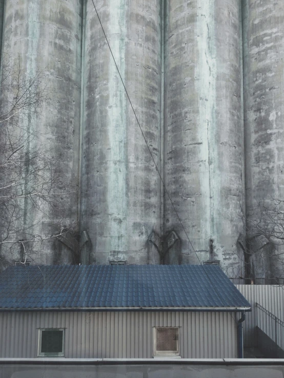 a building with a bunch of metal silos in the background