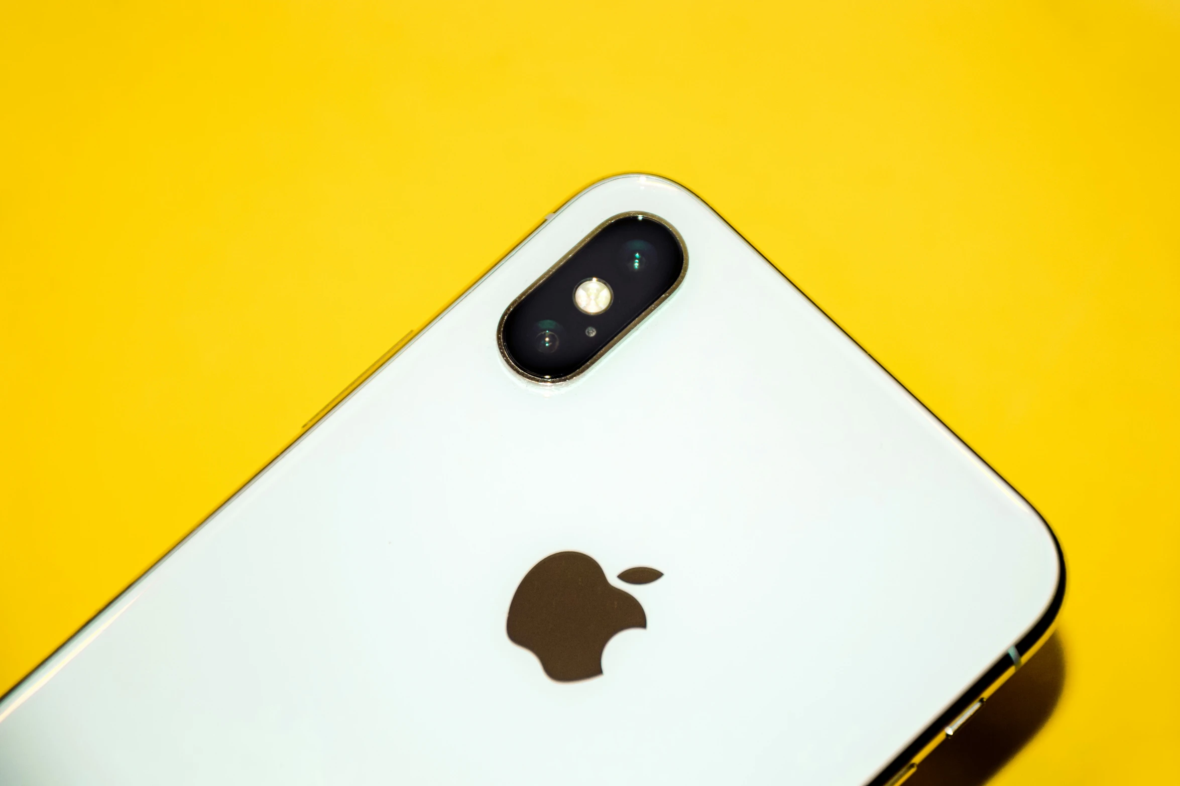 an apple iphone on a yellow background