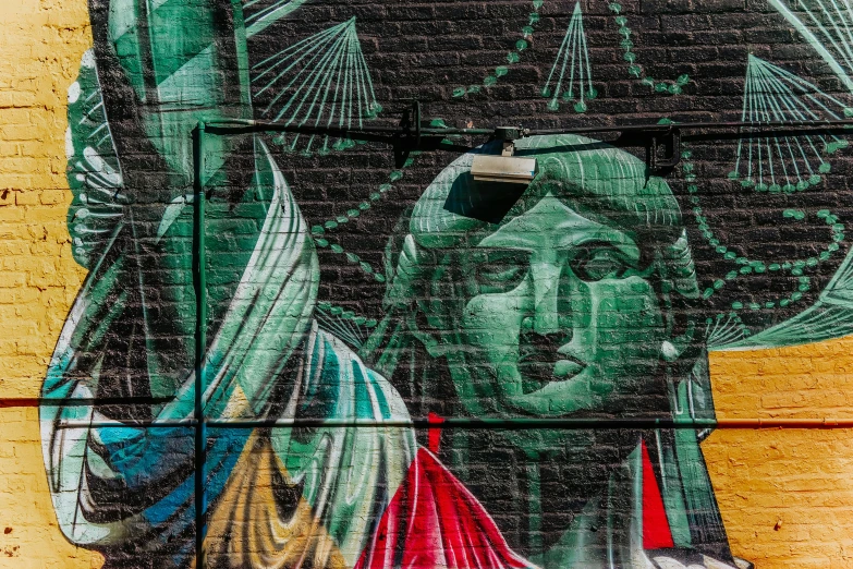 the statue of liberty painted on the side of a building