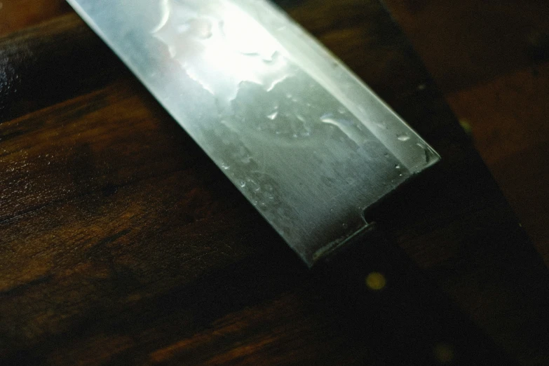 an old knife on a wood surface with black background