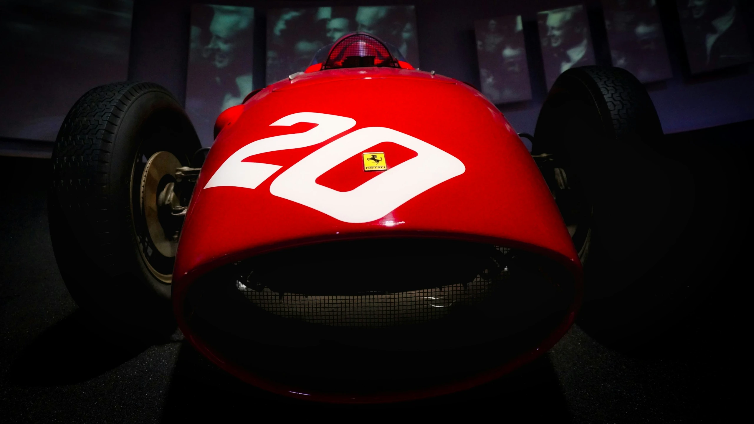 a red race car parked in a museum