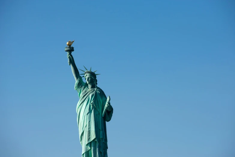 the statue of liberty looks toward the sky