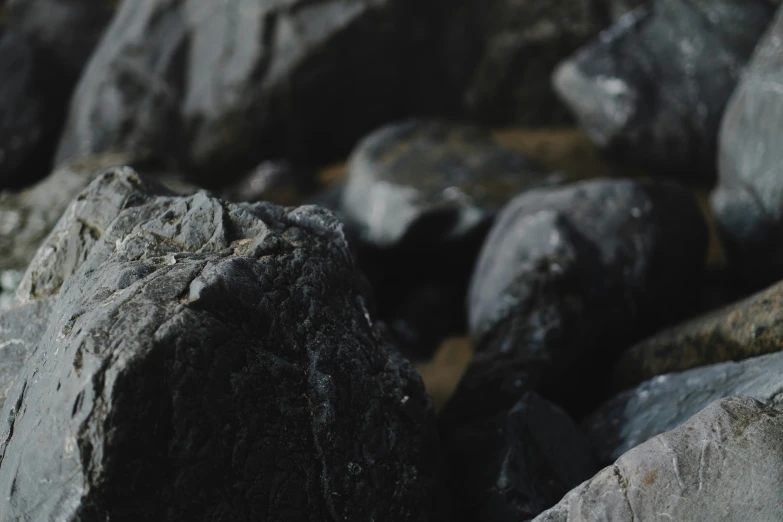 the rocks are grey and rocky by the water