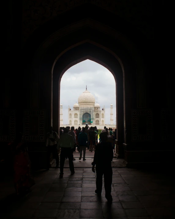 people are standing in a tunnel with a dome in the distance