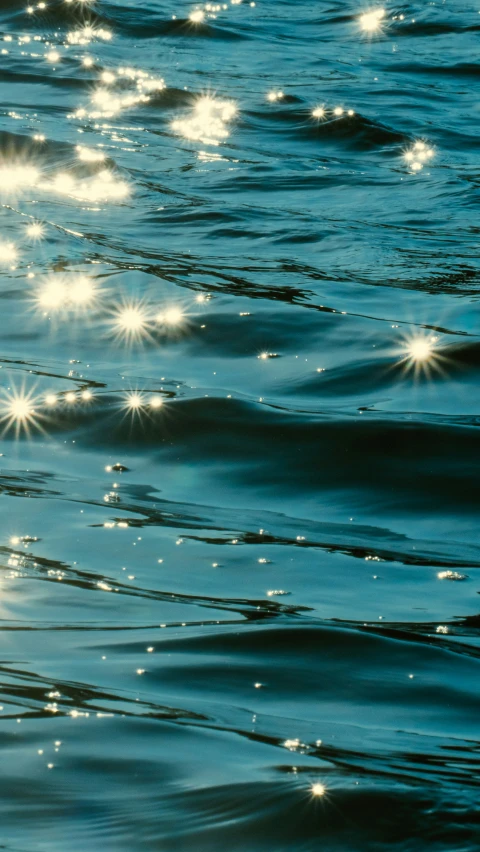 a blue water with many white rays on it