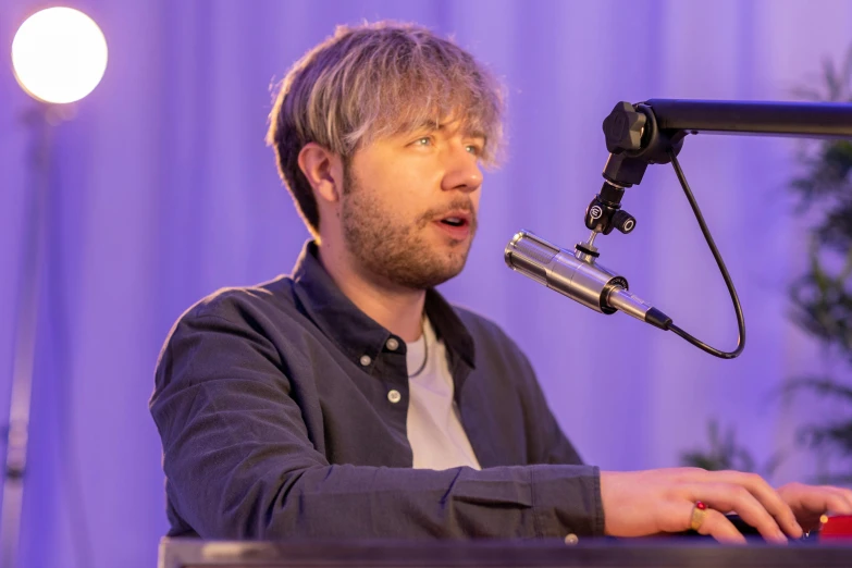 man with a microphone looking up into the air