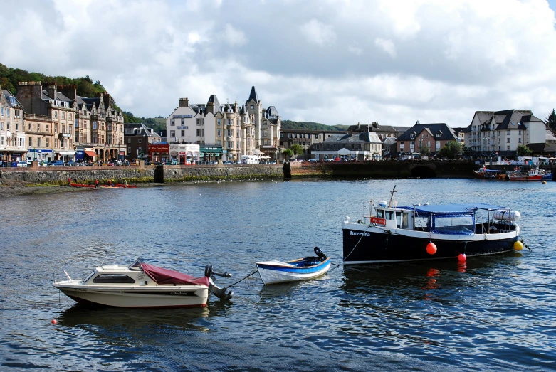 small boats are parked in the water next to each other