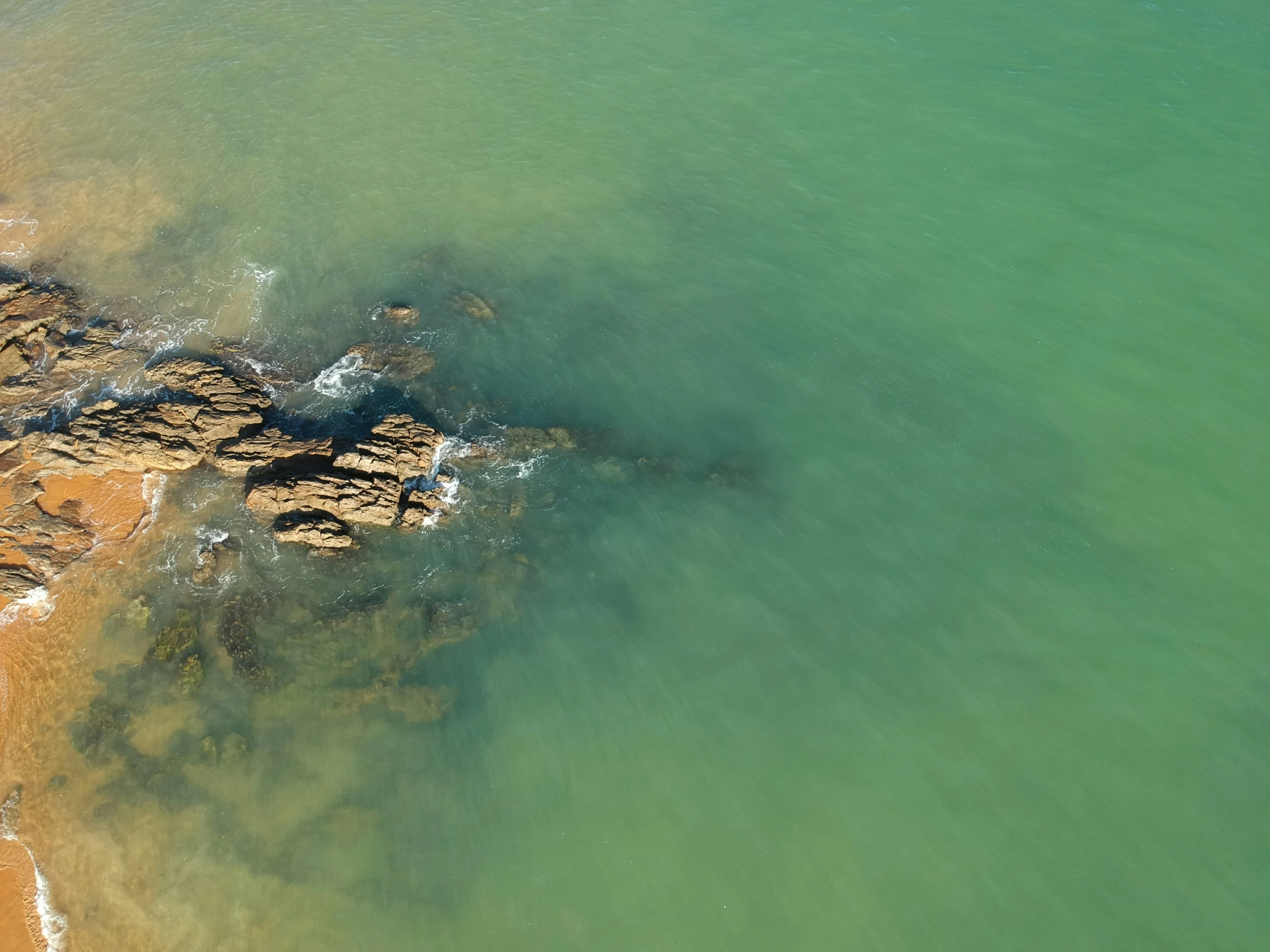 a view of some rocks from a small plane