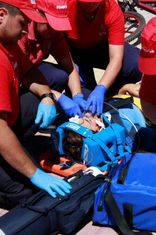 emergency response personnel preparing patient for procedure in outdoor setting