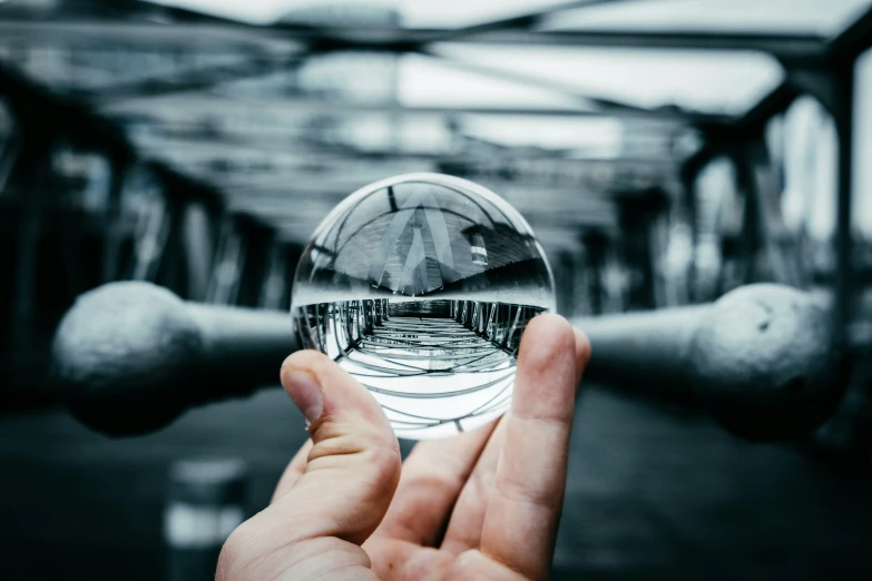 someone holding a glass ball on their finger