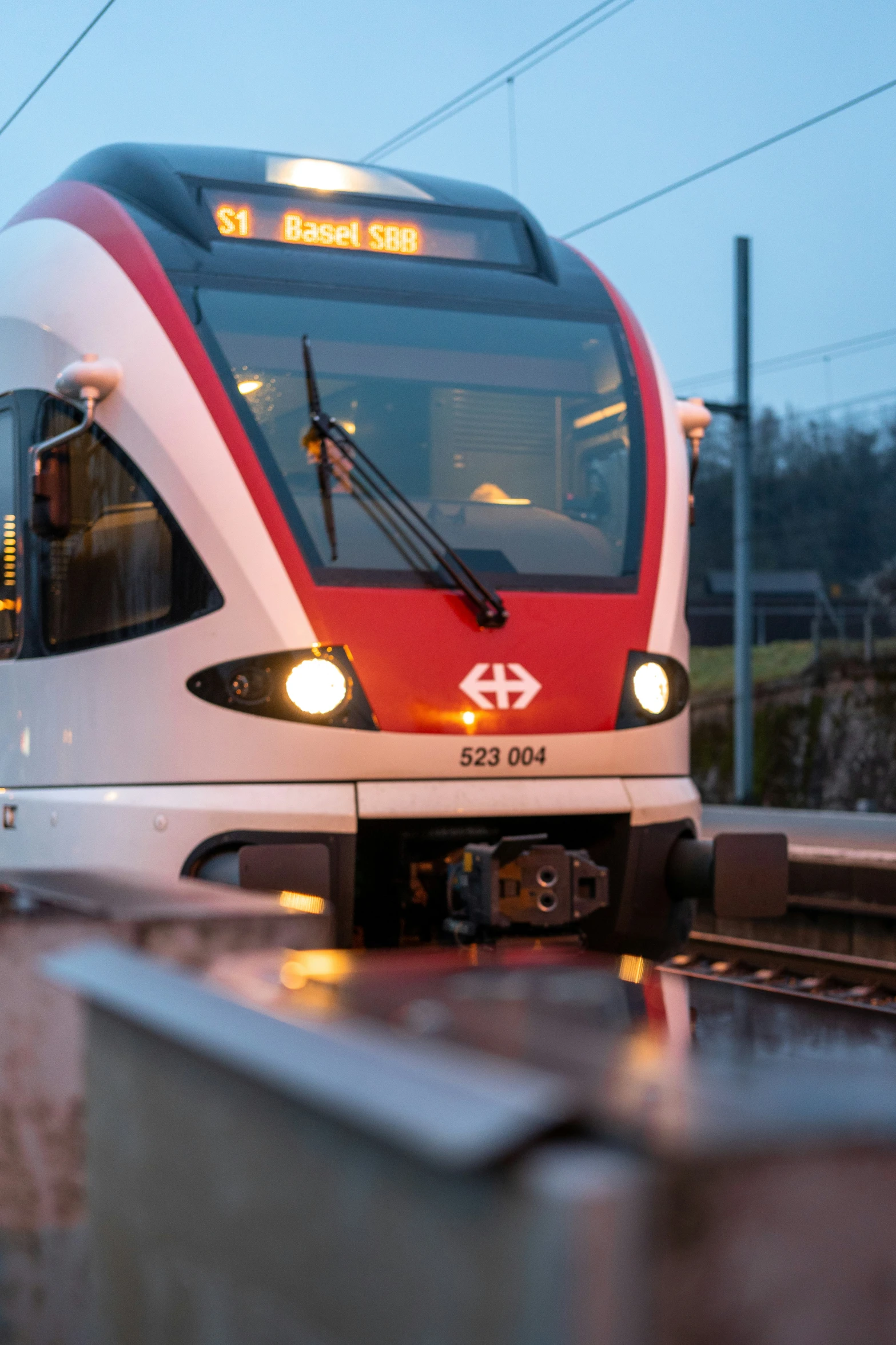 a train stopped at the station on the tracks