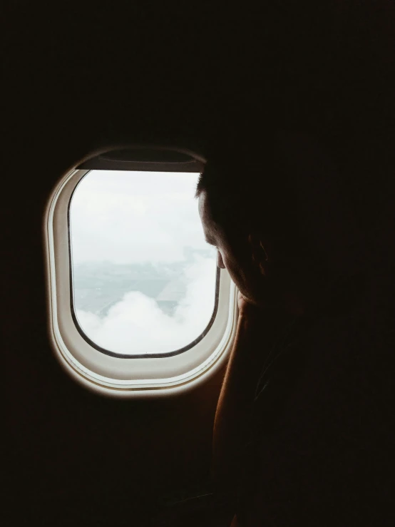 a man looks out of an airplane window