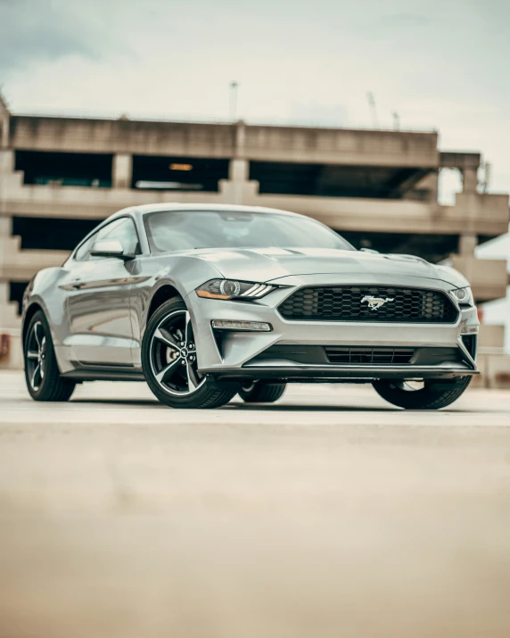 the front end of a grey ford mustang