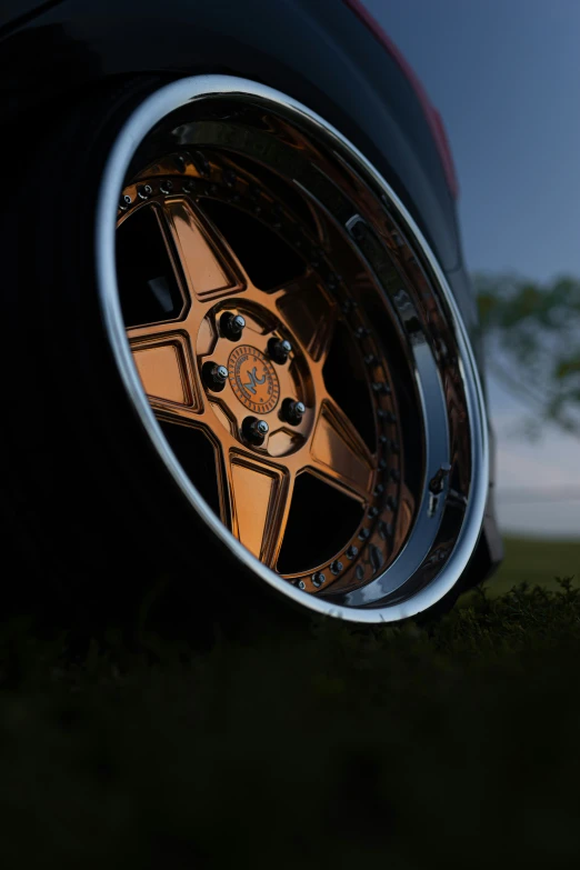 a car tire with a shiny spoke that's being polished gold