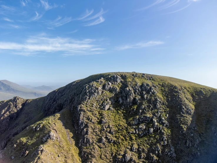 there is a large hill with a rocky side