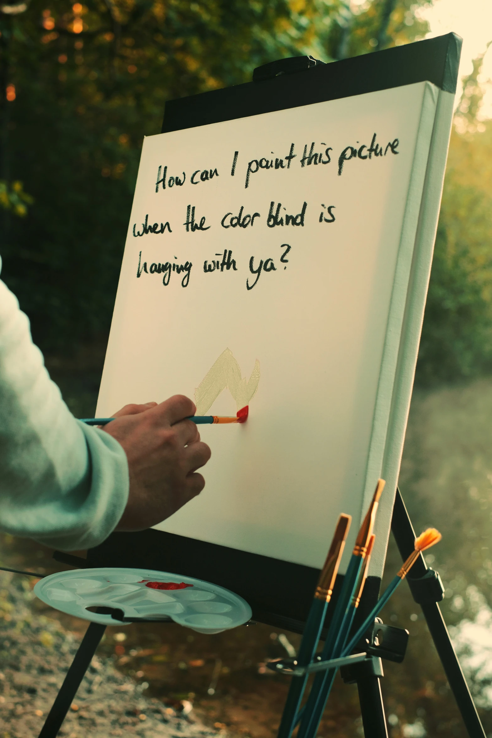 someone painting a poem on a canvas on an easel