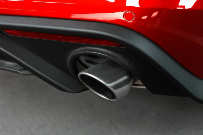 the rear view of a car with exhaust pipe