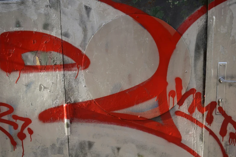 a white container covered in graffiti with red writing