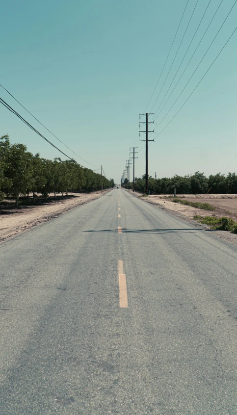 a person walks down the empty road of a deserted highway