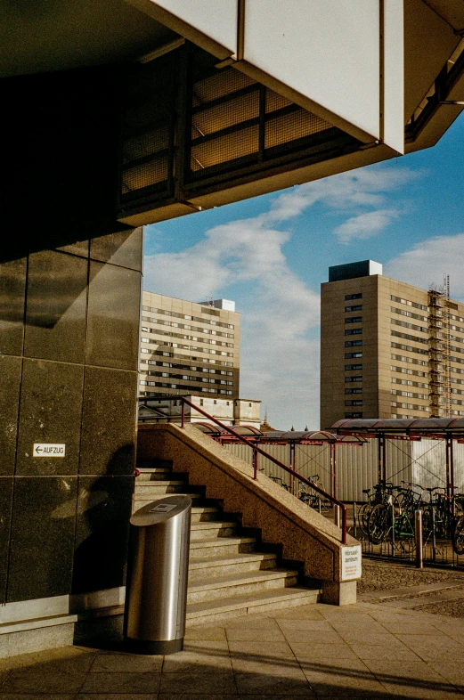 the stairs lead up to several tall buildings