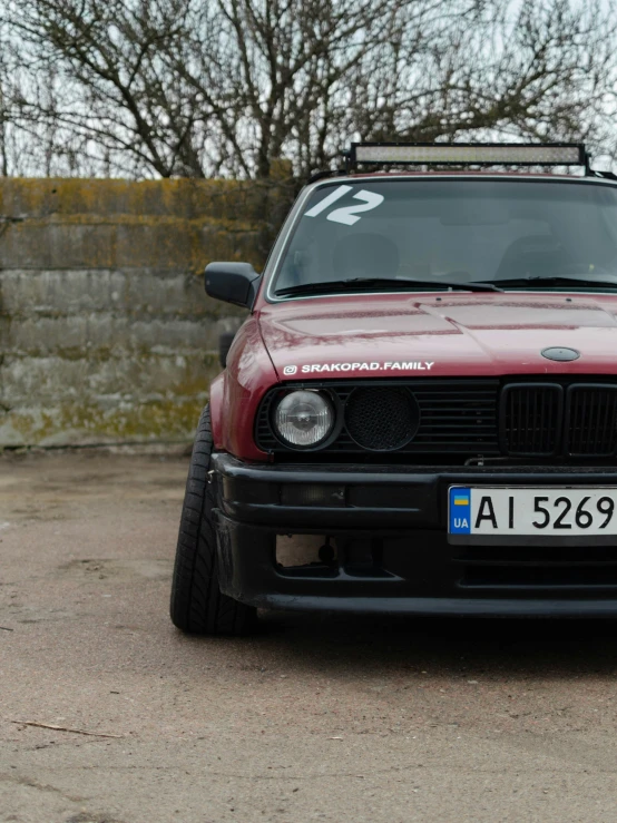 a red vehicle parked near a stone wall