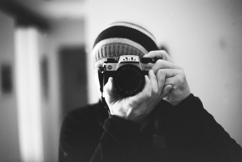 a woman taking a po with her camera in a bathroom