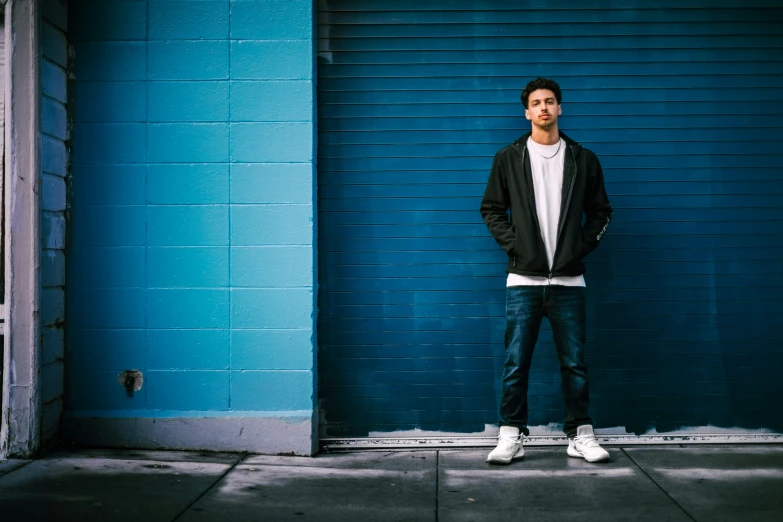 a man in front of a blue wall