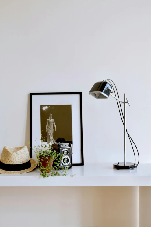 a pograph and hat sit on a shelf