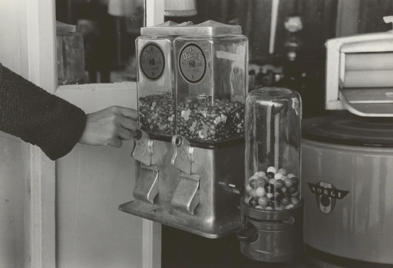 a man is holding up a can filled with candy