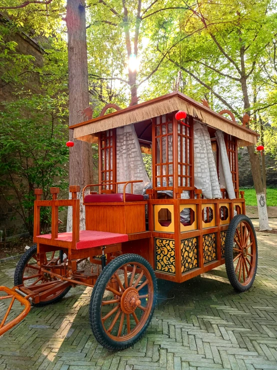 a wooden carriage on display in the park