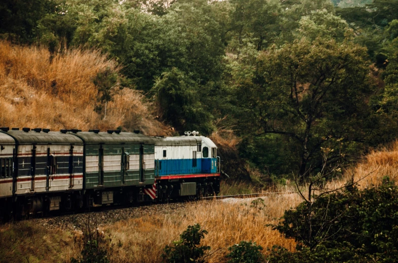 a white and blue train on the tracks