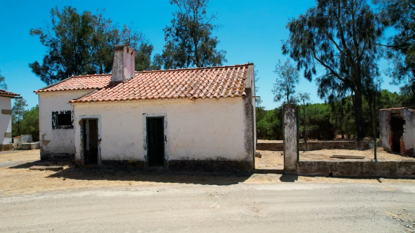there is an old white house in the rural countryside