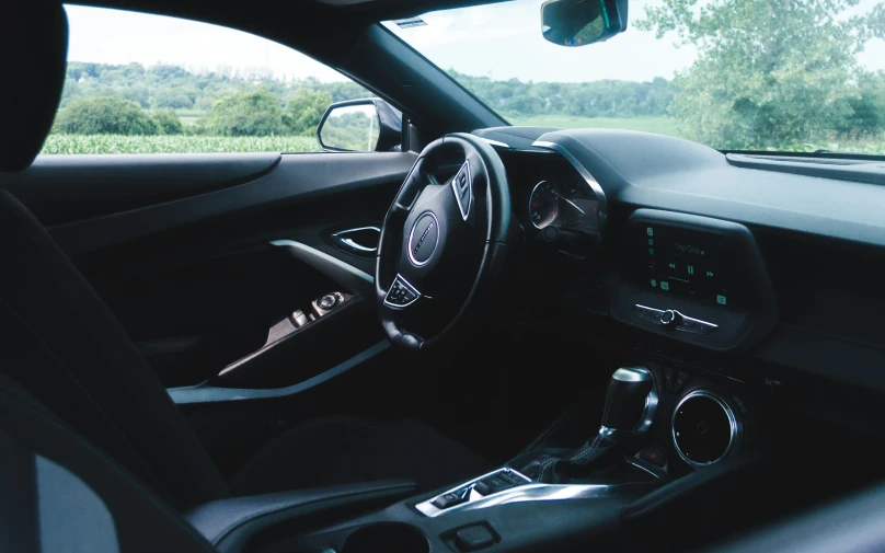 inside the dashboard of a compact automobile with a screen and dashboard