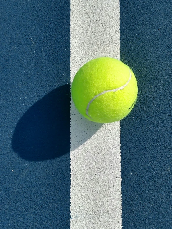 there is a tennis ball on the court