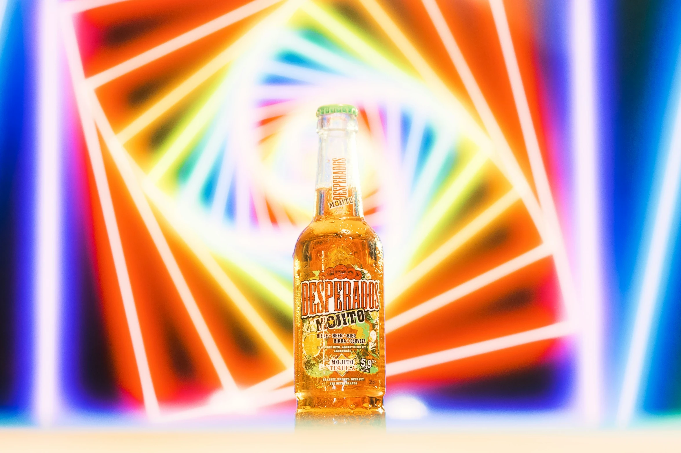 a bottle of alcohol with neon colored light shining