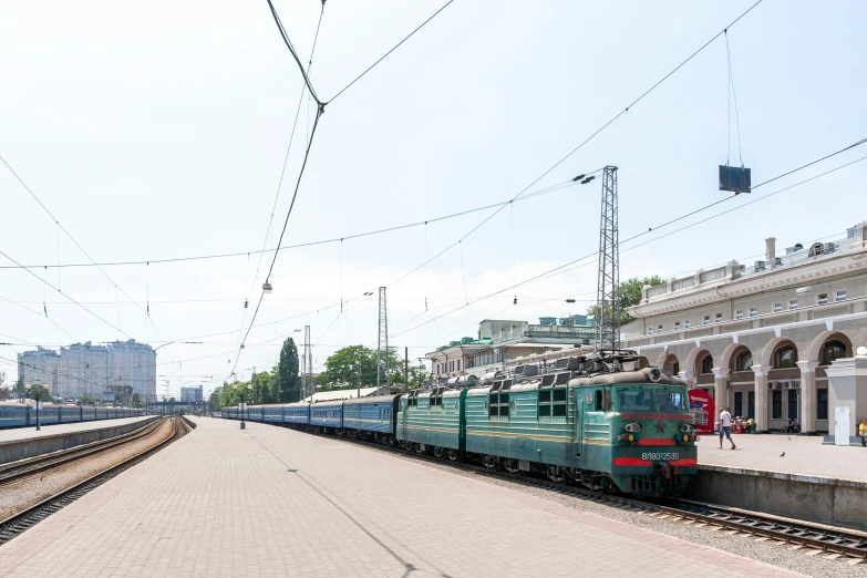 a train traveling past a tall white building