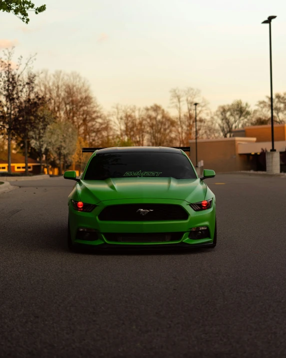 a green car parked in a parking lot